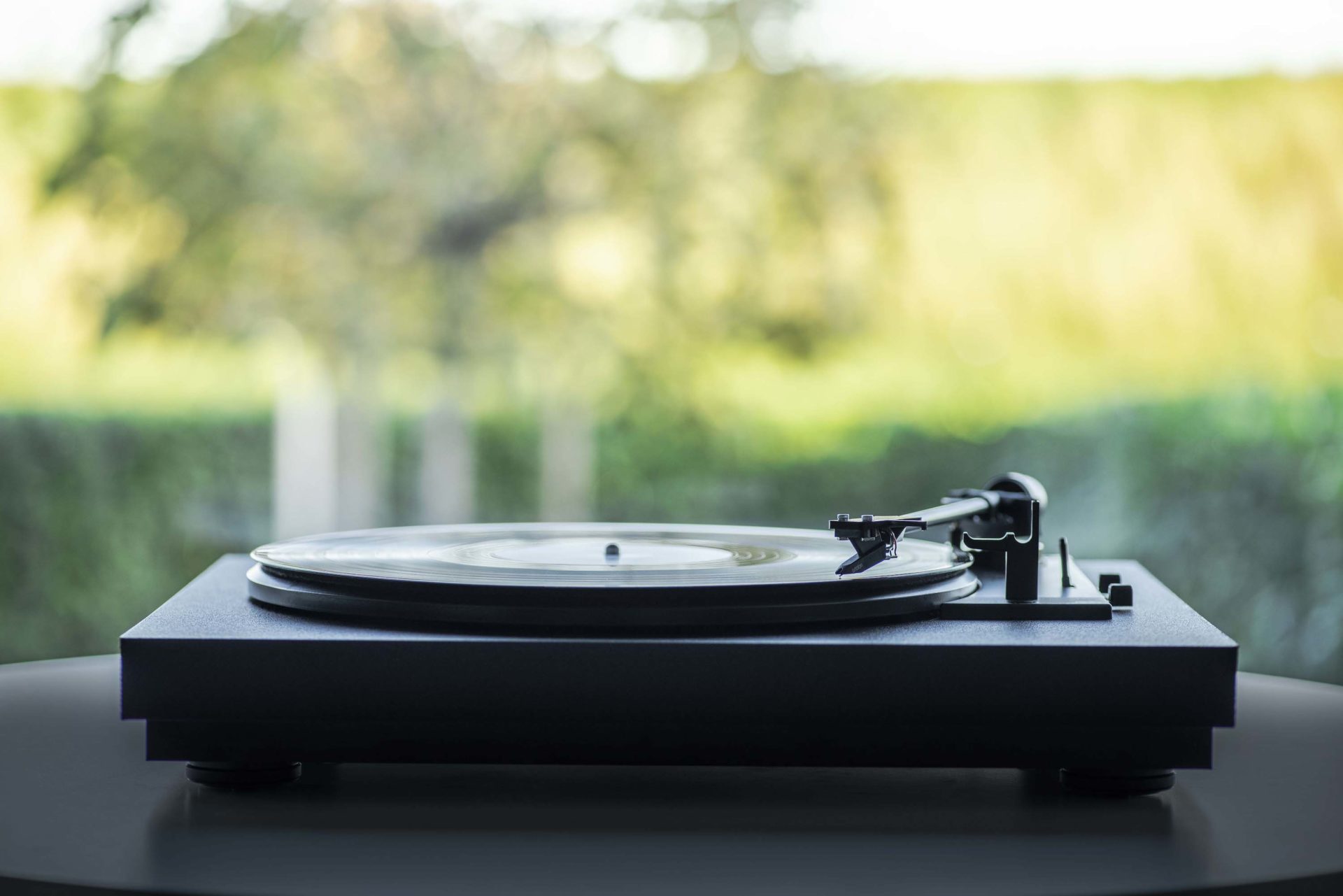 turntable with greenery in the background