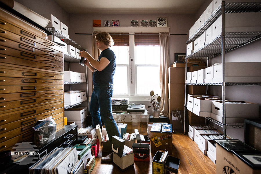 Ben Blackwell looking through boxes in a room full of records