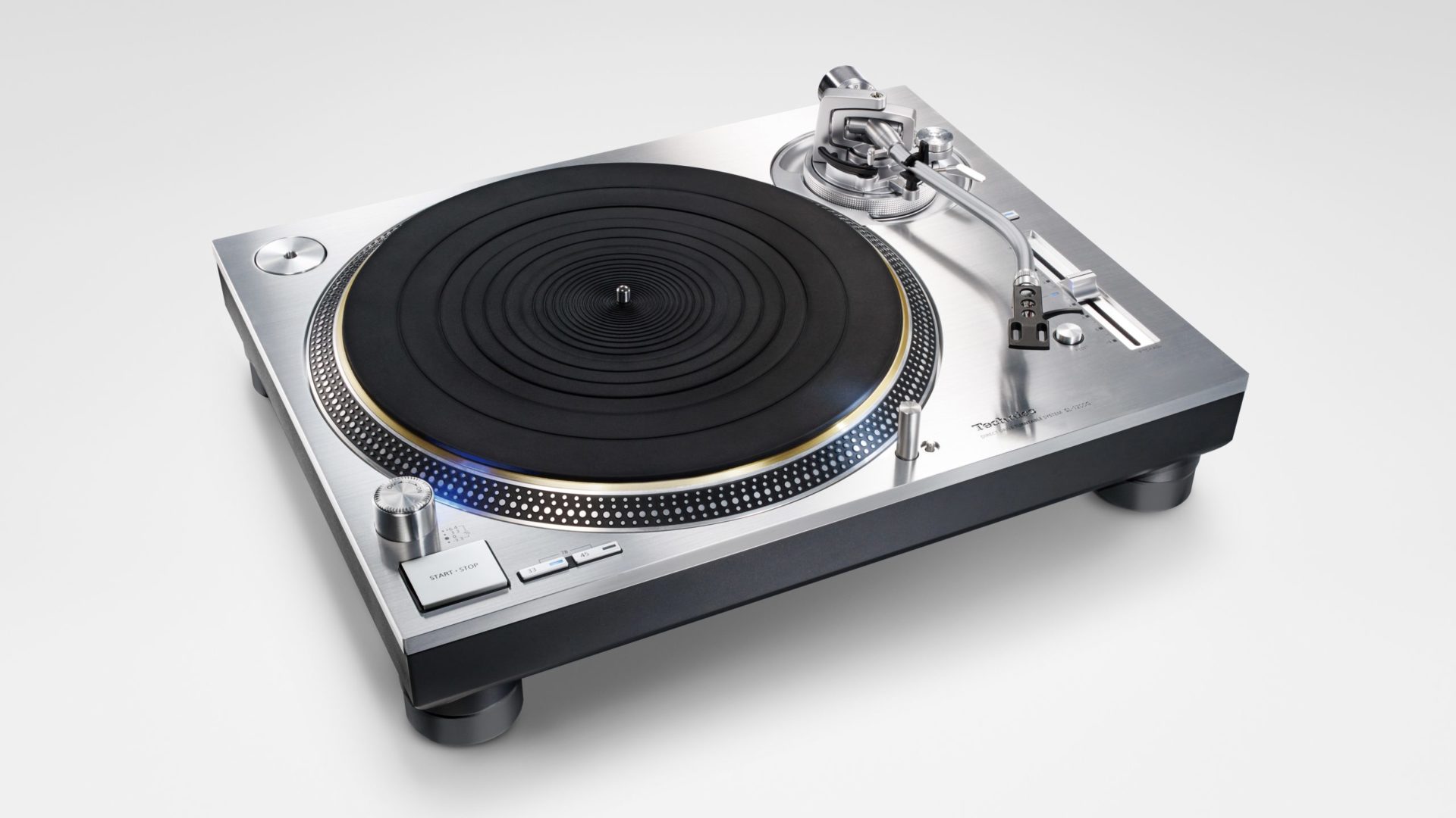 a silver technics turntable with black rubber mat on the platter
