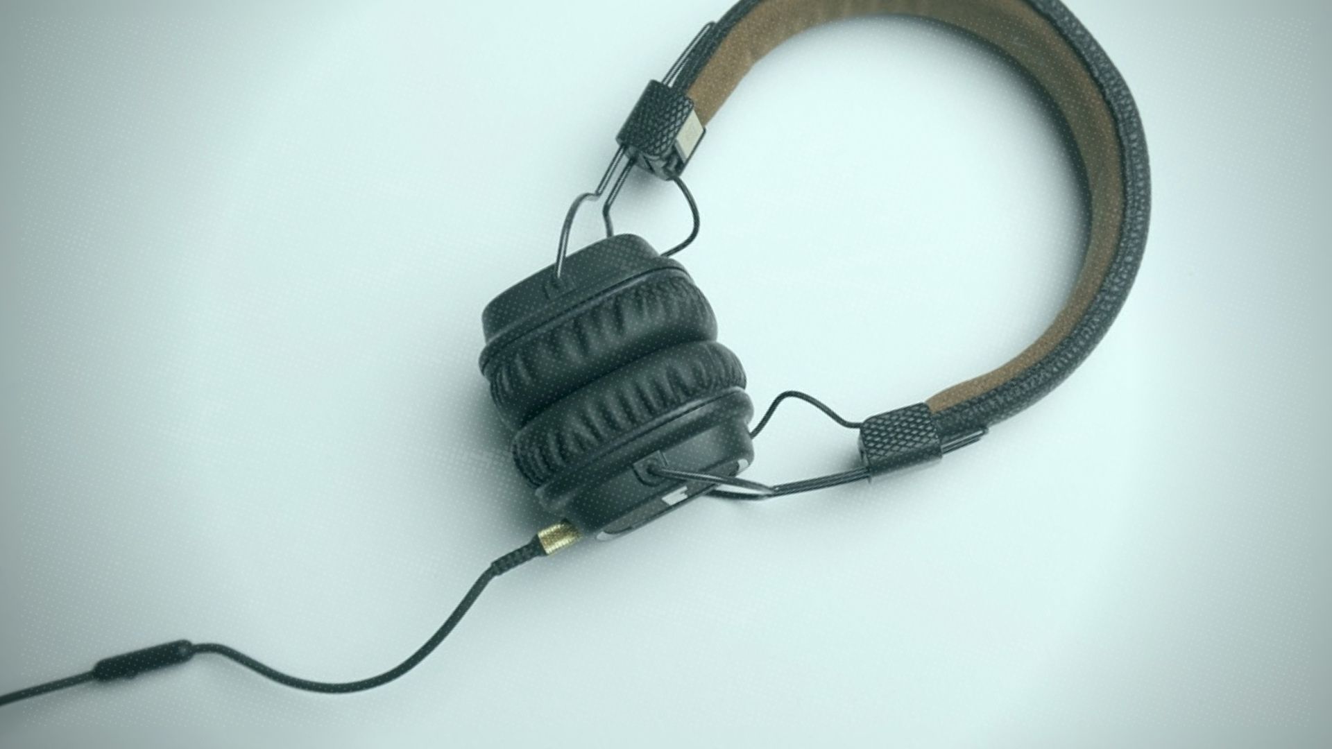 A pair hi fidelity headphones laying on a table