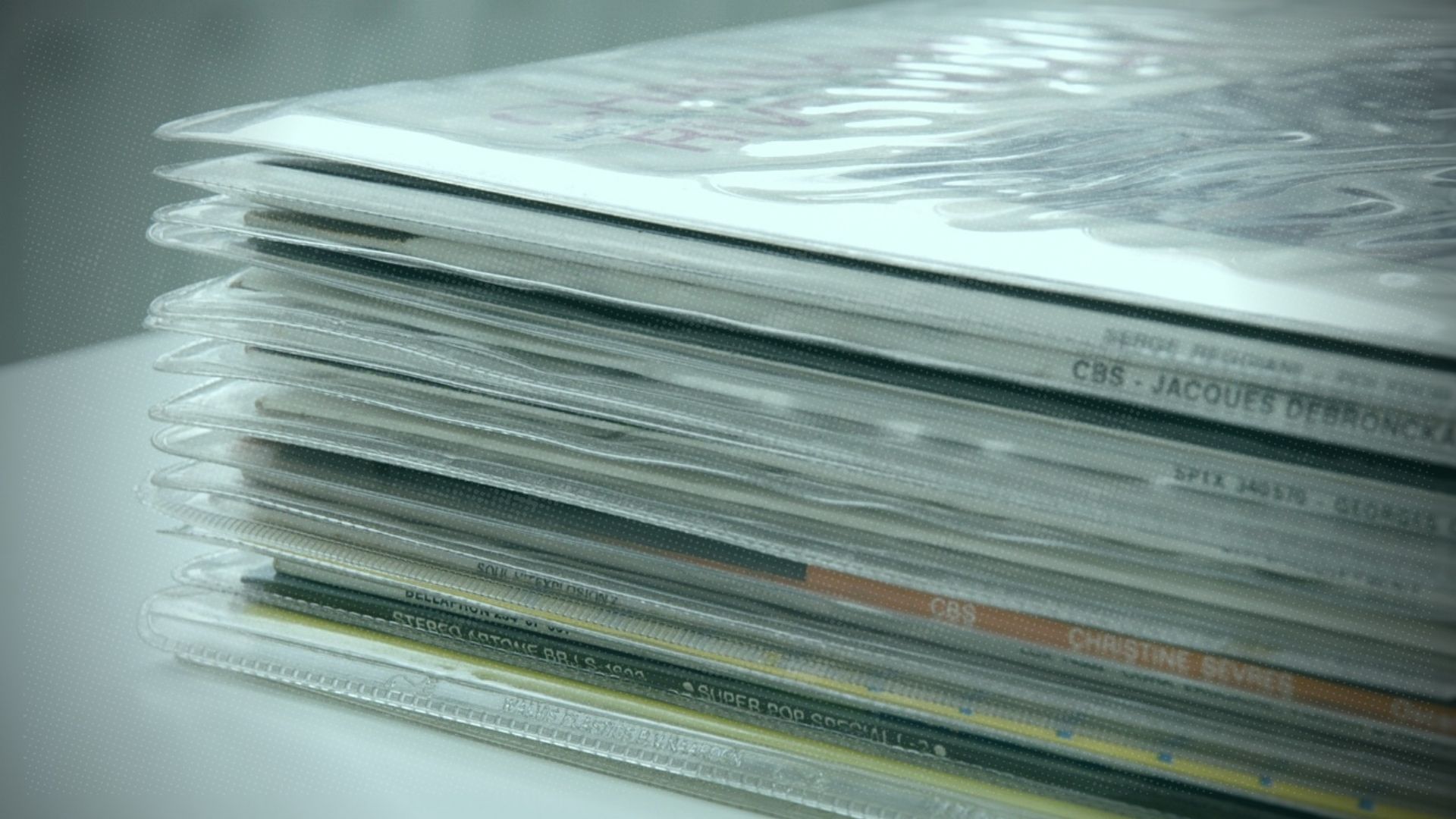 A stack of vinyl records in sleeves