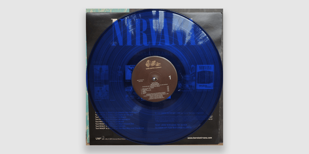 photo of a translucent blue vinyl release of nirvana's nevermind with the record sitting on the inner sleeve
