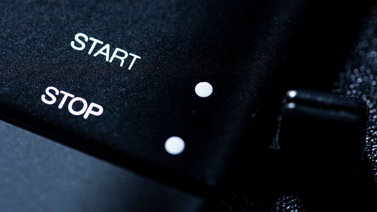 Close up photo of a start and stop button on a turntable