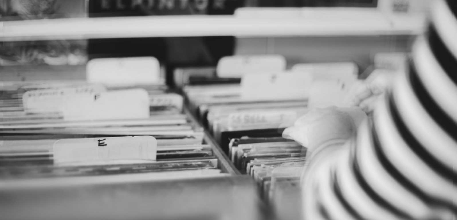 blurry photos of a person flipping through record bins in a record store