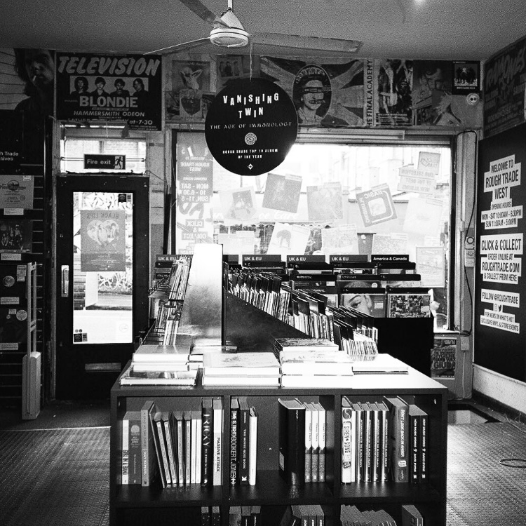 A black and white image of the inside of Rough Trade West, a record store in London England