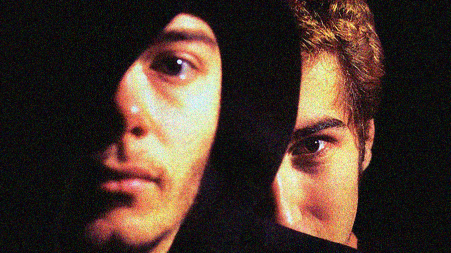 A picture of the 2 members of Daft Punk without their infamous masks on. The image is close up and mysterious.