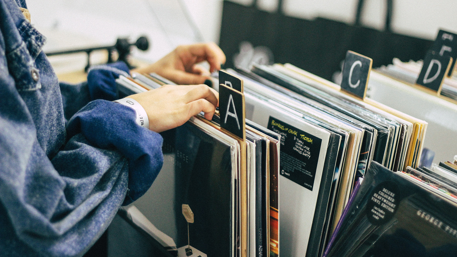 women browsing through vinyl records