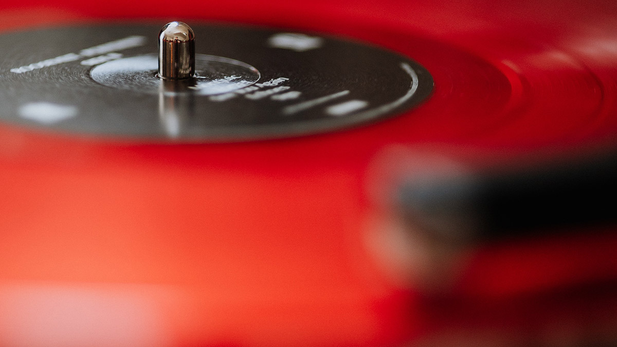 red vinyl record spinning on a turntable