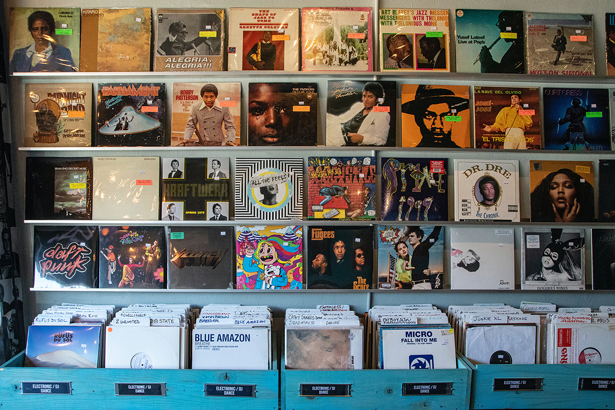 shelves of vinyl records on display in record store