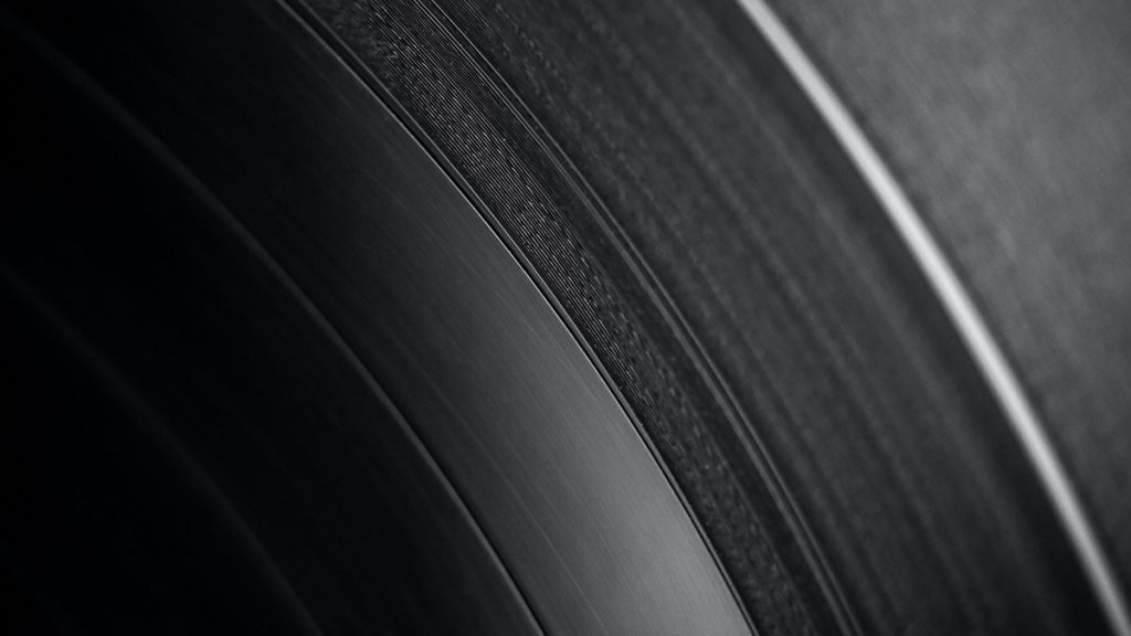 close-up view of the grooves on a black vinyl record