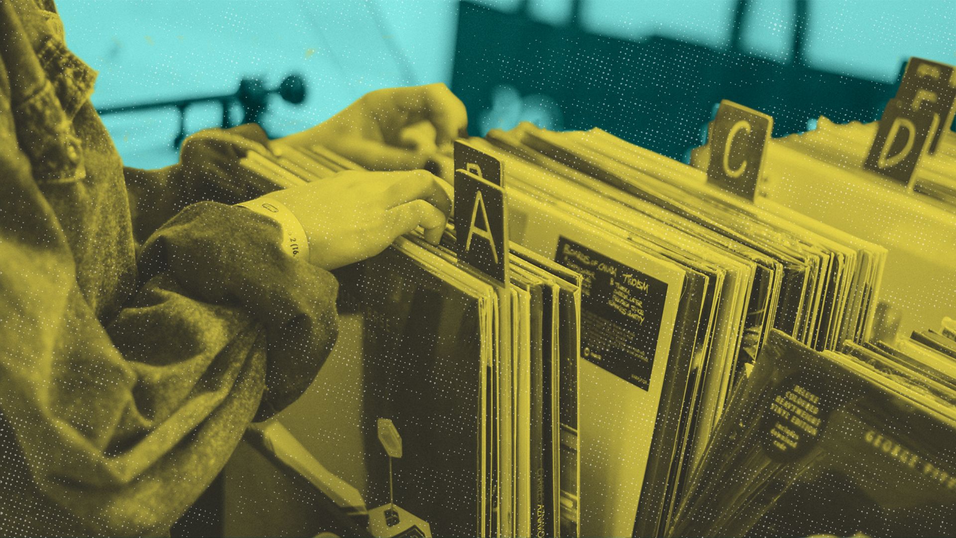 woman flipping through vinyl records on a shelf
